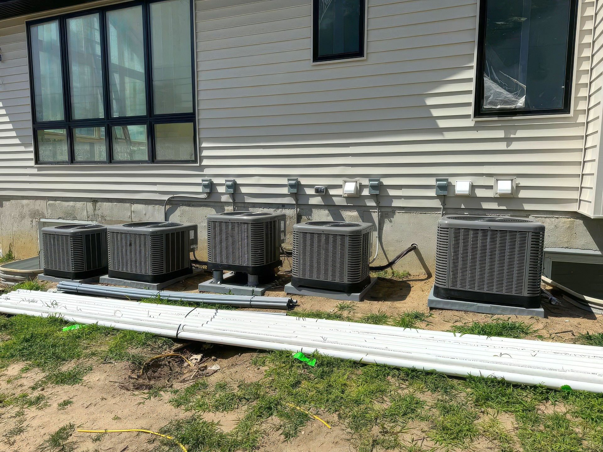 As a result of construction of new house, an air conditioner is being installed outside to serve residential needs of residents